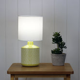 Celia Yellow Yellow Ceramic Table Lamp styled in a room