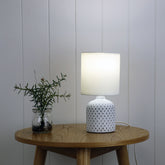 Vera White Ceramic Table Lamp styled in a room