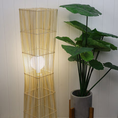 Jambi Rattan Cane Floor Lamp styled in a room