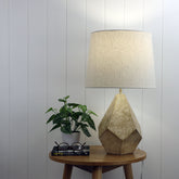Leon Geometric Ivory and Gold Table Lamp styled in a room