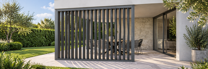 Charcoal aluminium adjustable vertical shutters partly open beside a modern outdoor dining area