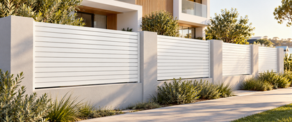 White horizontal aluminium slat fencing between rendered pillars outside a modern Australian home