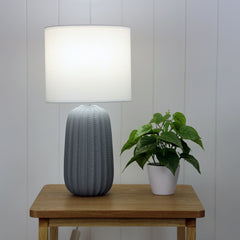 Benjy.25 Grey Ceramic Table Lamp styled in a room
