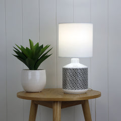 Celia White Ceramic Table Lamp styled in a room