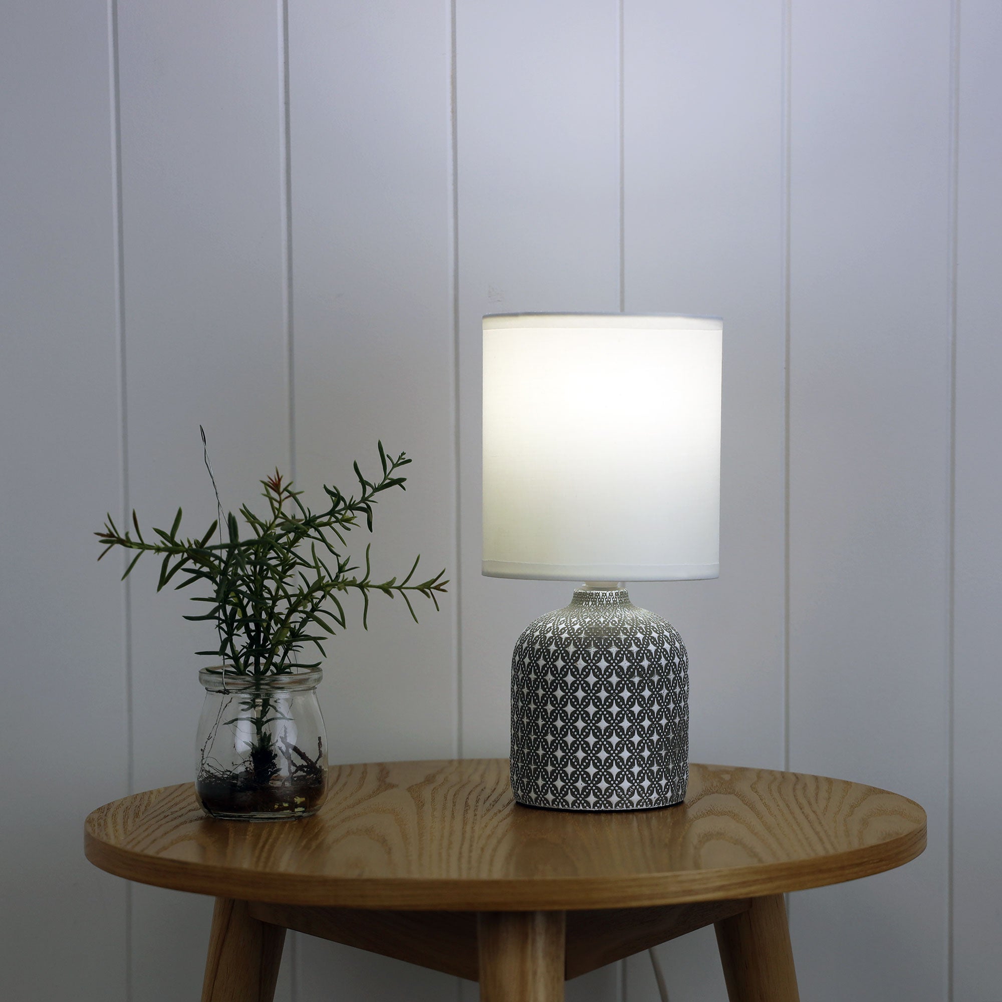 Vera Grey Ceramic Table Lamp styled in a room