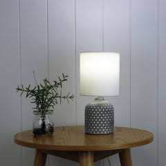 Vera Grey Ceramic Table Lamp styled in a room