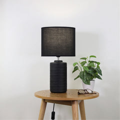 Jenny Black Ceramic Table Lamp styled in a room