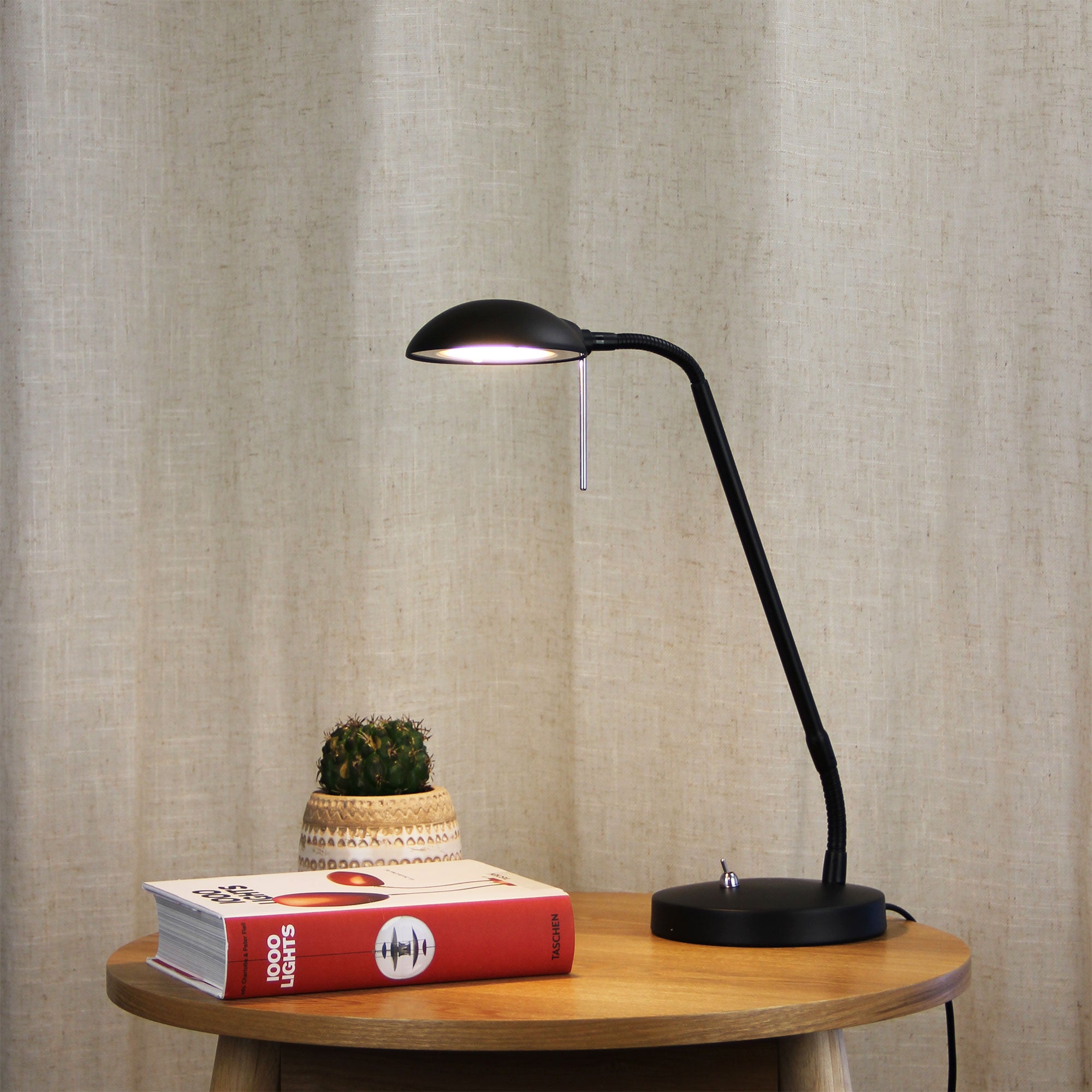 Timo Black LED Desk Lamp styled in a room