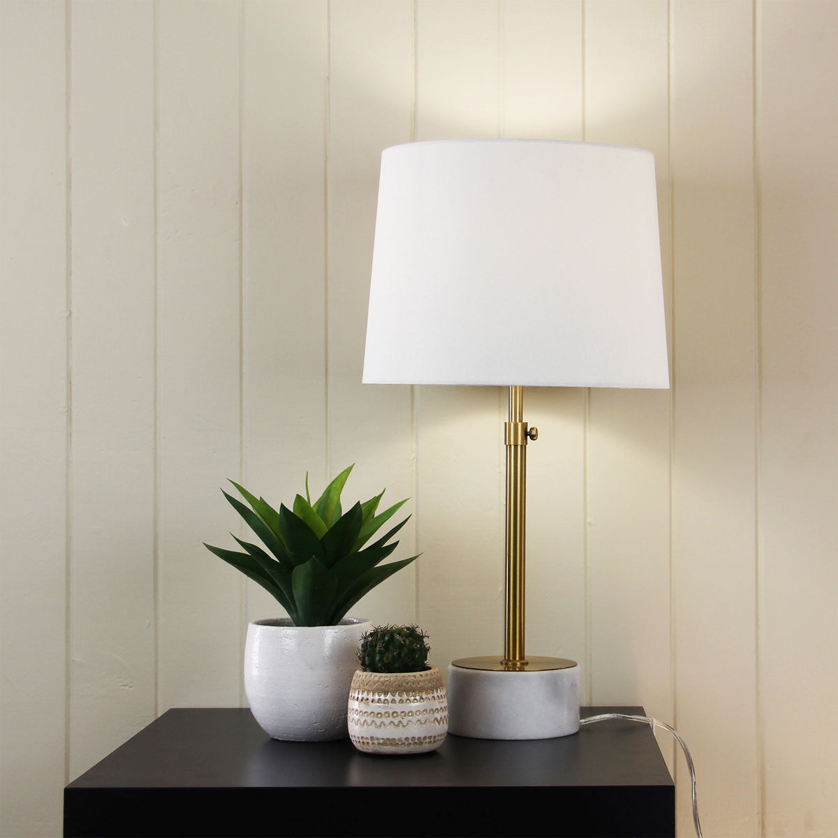 Umbria Height Adjustable Scandi Lamp in Antique Brass styled in a room