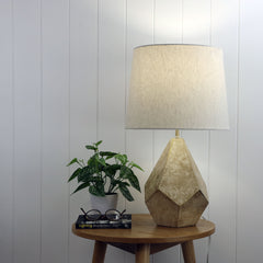 Leon Geometric Ivory and Gold Table Lamp styled in a room