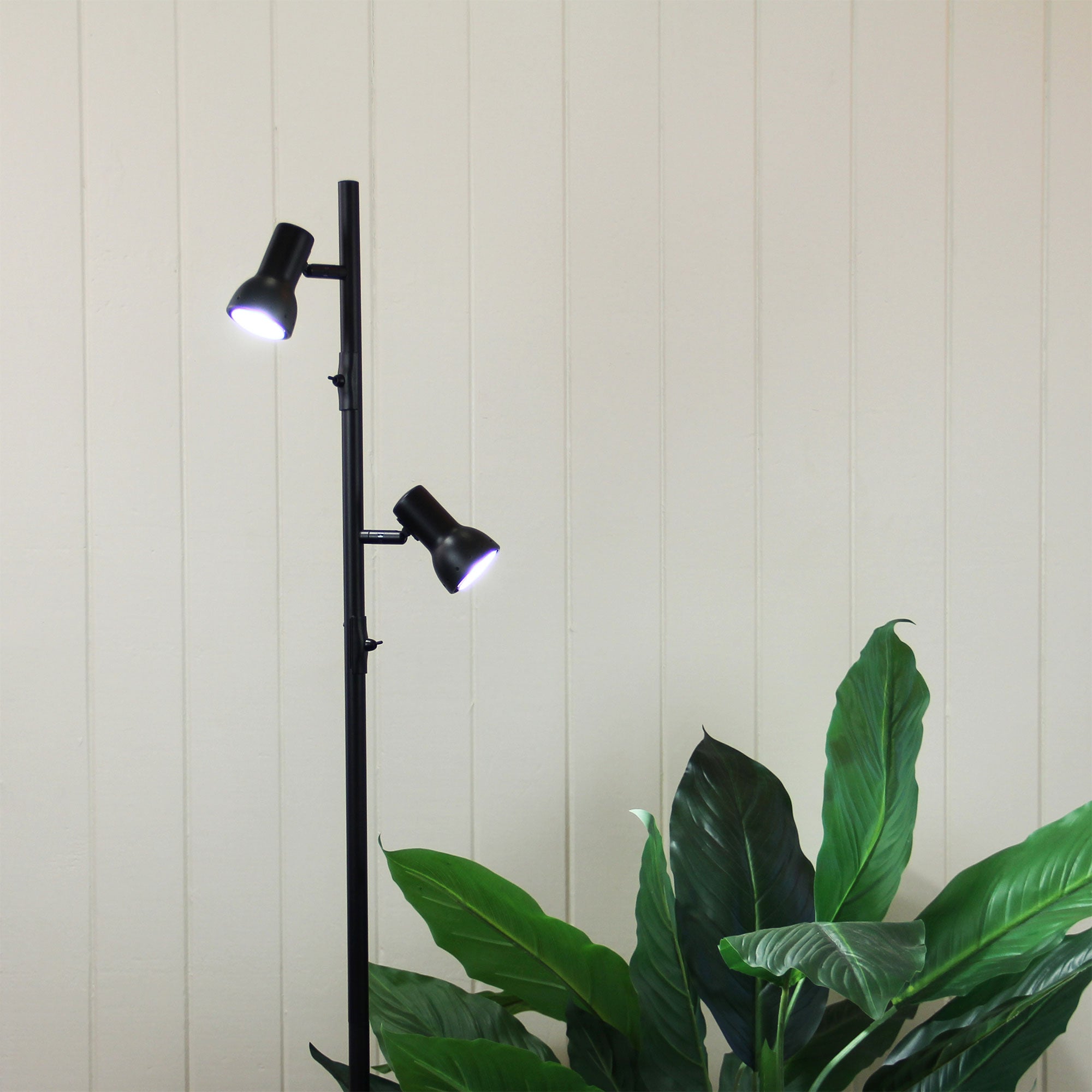 Daxam Twin Adjustable Floor Lamp styled in a room