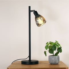 Alma Smoked Glass Desk Lamp styled in a room
