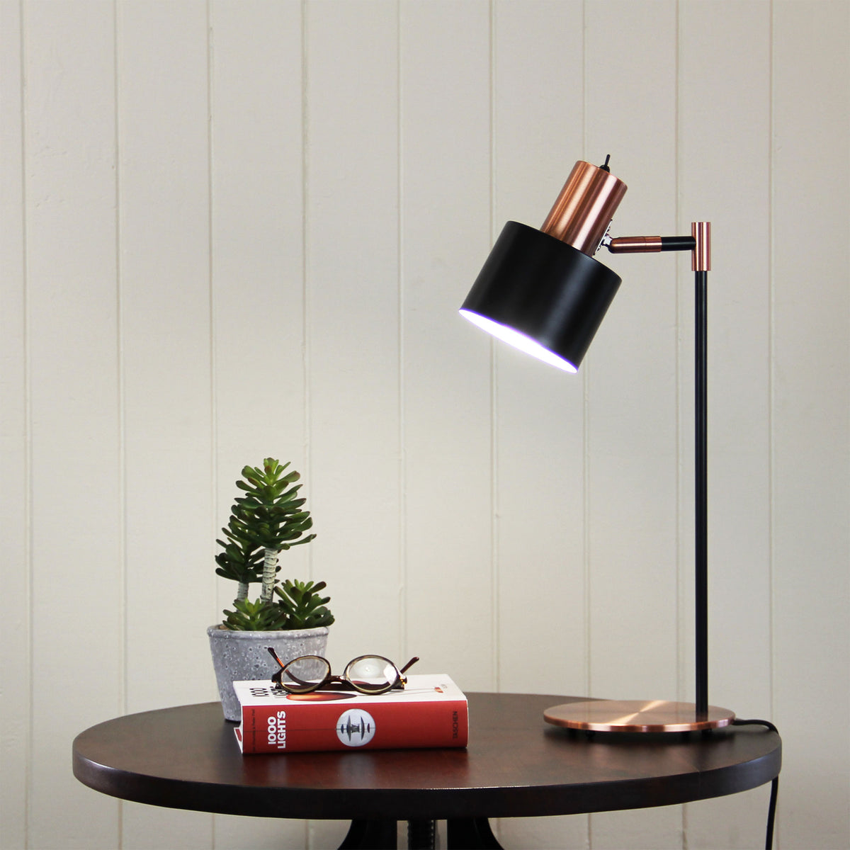 Ari Mid-century Desk Lamp Black and Brushed Copper styled in a room