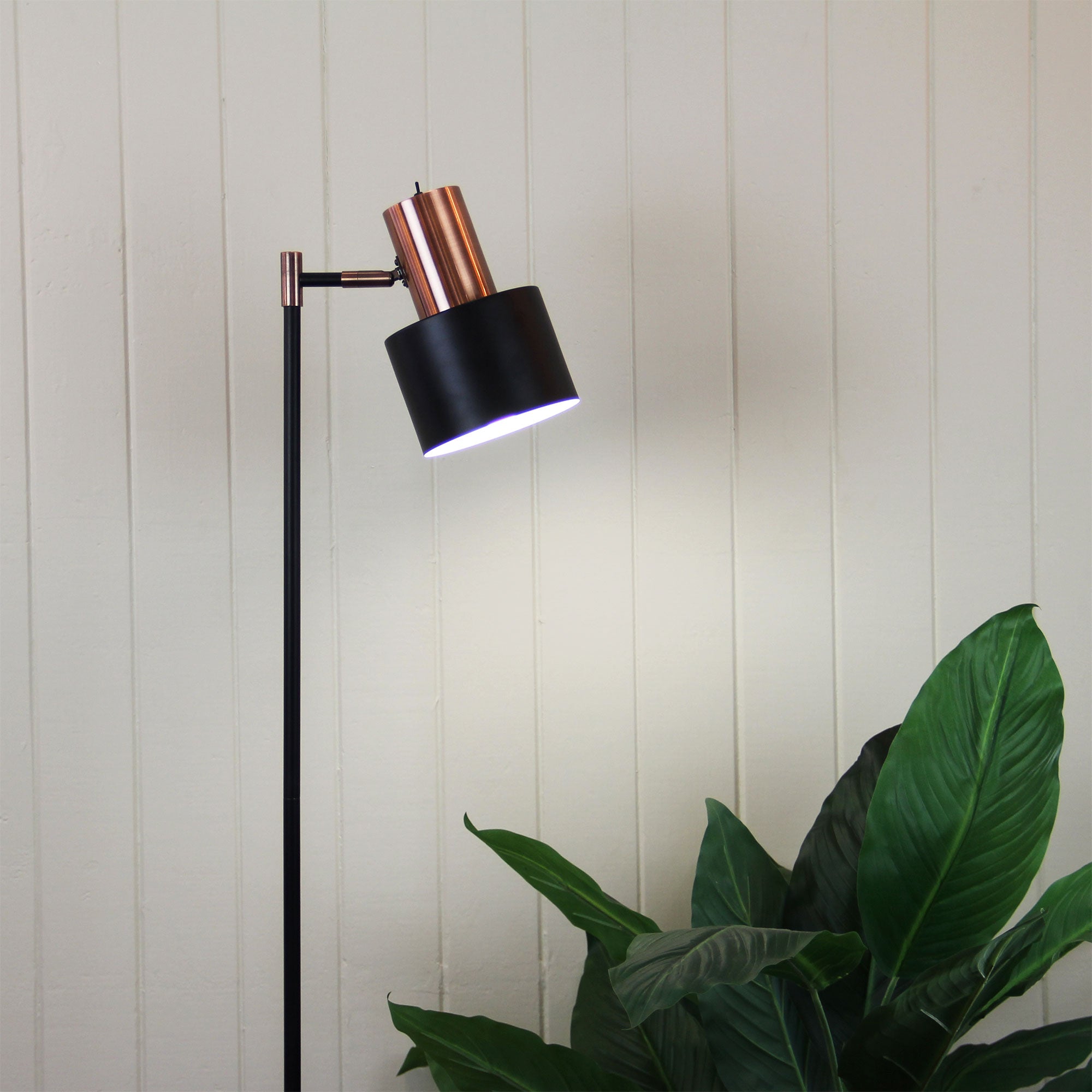 Ari Mid-century Floor Lamp Black and Brushed Copper styled in a room
