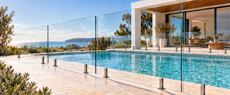 Frameless glass pool fencing with tall slim polished spigots, two per fixed panel